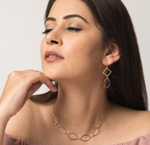 Fairtrade jewellery. Handmade jewellery of golden brass earrings and necklace with geometric shapes
