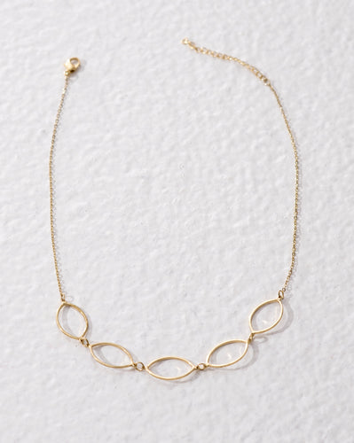 Ethical fashion jewellery. Short golden brass necklace with hollow geometric shapes. Made in India.