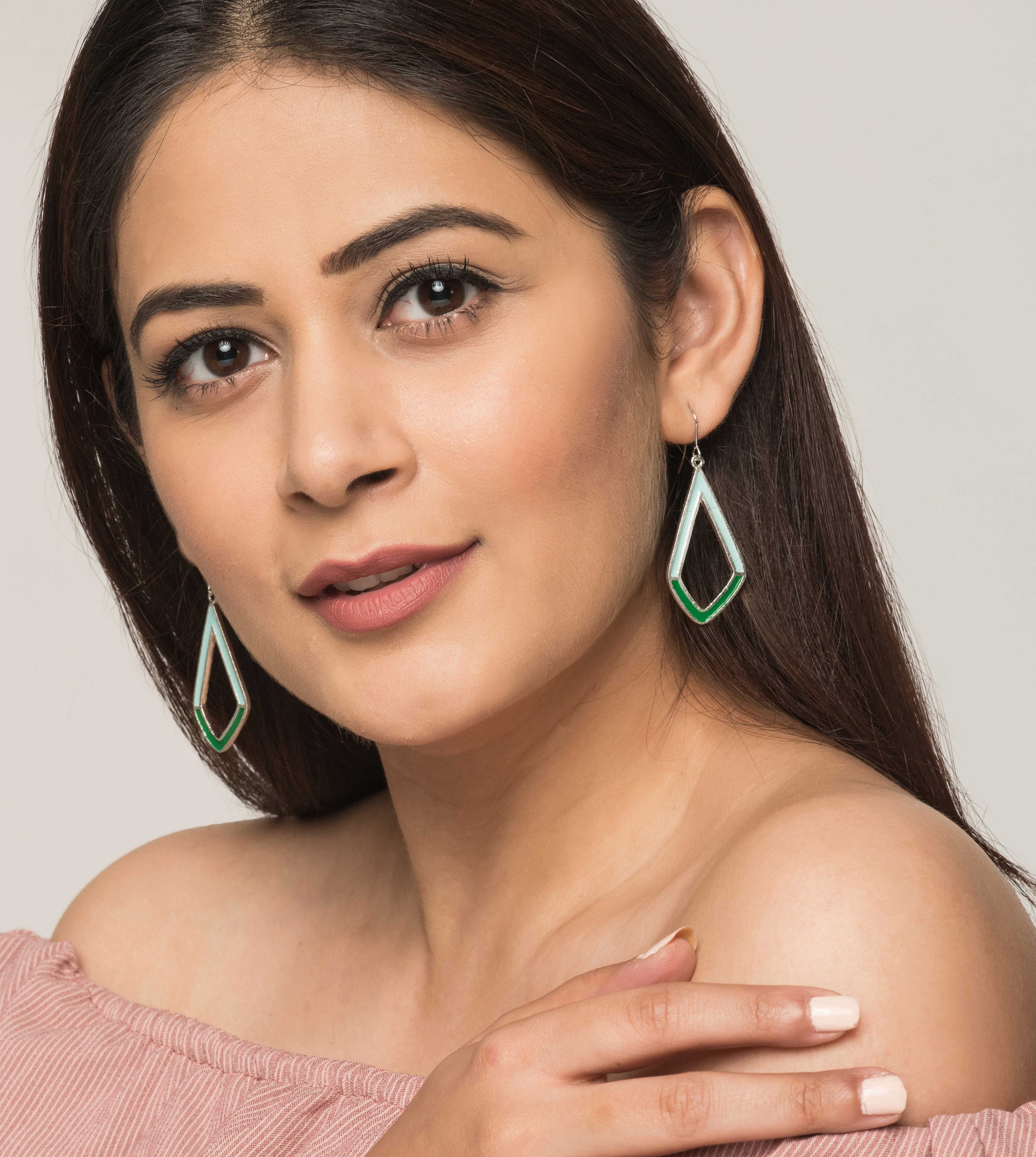 Woman wearing blue and green geometric fair trade jewellery earrings. Ethical fashion & sustainable.