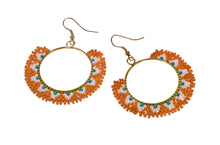 Intricately constructred piece of ethical jewellery. Colourful earrings made of orange glass beads. 