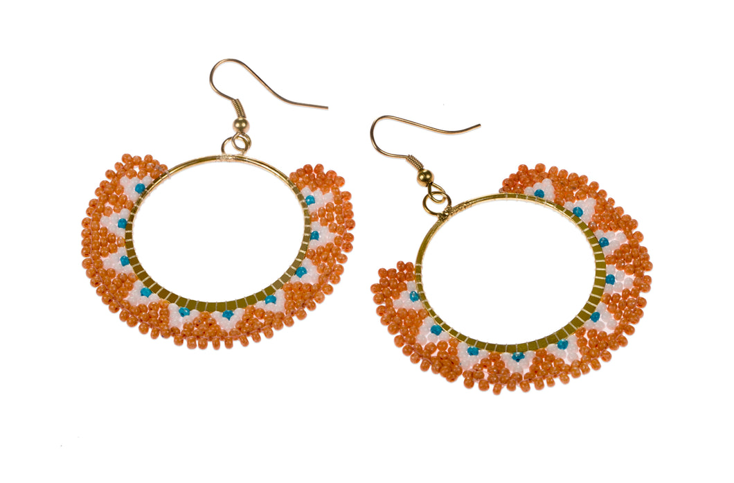 Intricately constructred piece of ethical jewellery. Colourful earrings made of orange glass beads. 