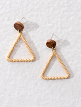 Hollow triangular earrings made of raffia and wood. All natural and eco-friendly, yet contemporary.